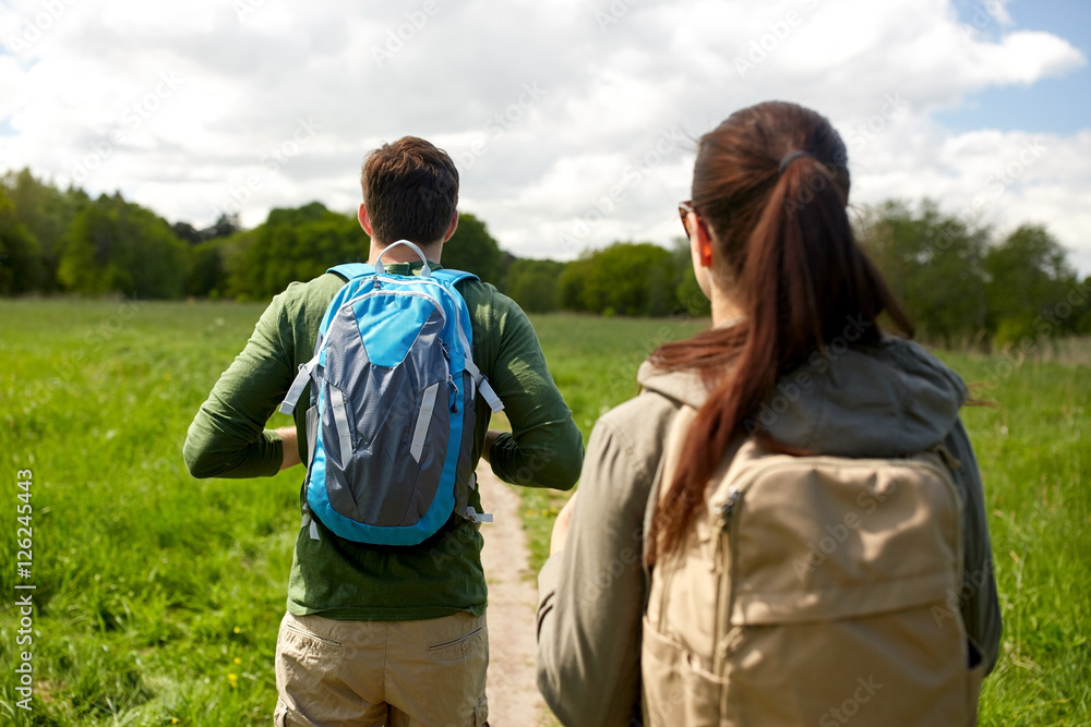 close up of couple with backpacks hiking outdoors close up of couple with backpacks hiking outdoors