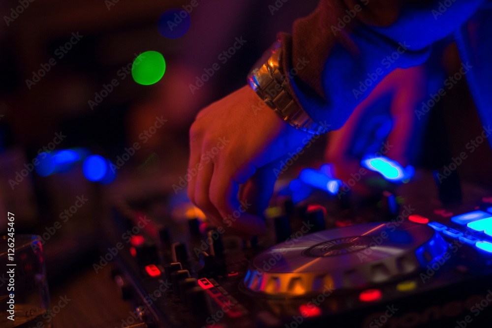 DJ turntable console mixer controlling with two hand in concert nightclub stage. DJ turntable console mixer controlling with two hand in concert nightclub stage.