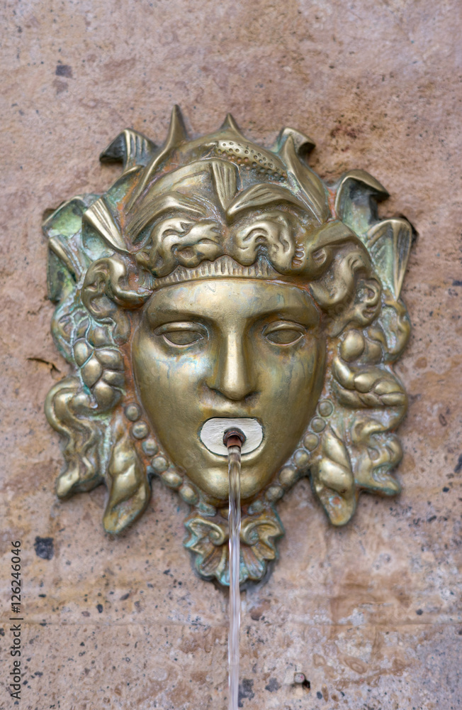Fountain with head form pouring water through his mouth Fountain with head form pouring water through his mouth