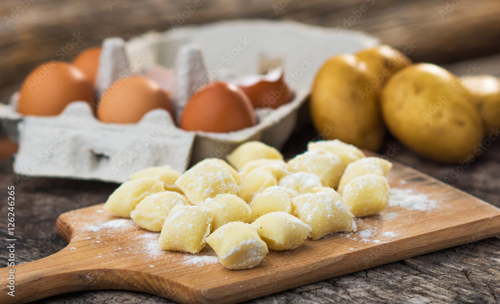 Uncooked homemade gnocchi on cutting board Uncooked homemade gnocchi on cutting board
