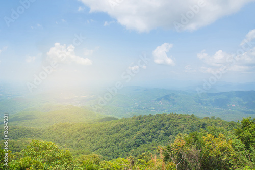 Field of spring grass and mountain with sunlight in Thailand