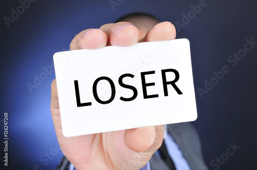 man with a signboard with the word loser photo