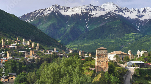 Mestia town panorama with ancient Svan Towers and Caucasus mountains in the background, Svaneti, Georgia photo