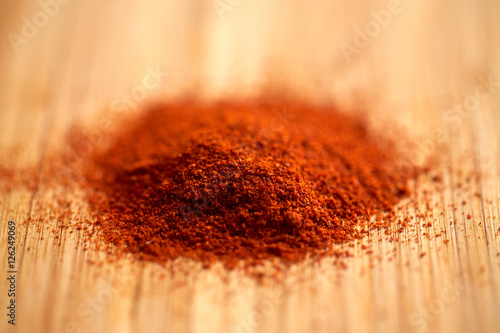 cayenne pepper or paprika powder on wood