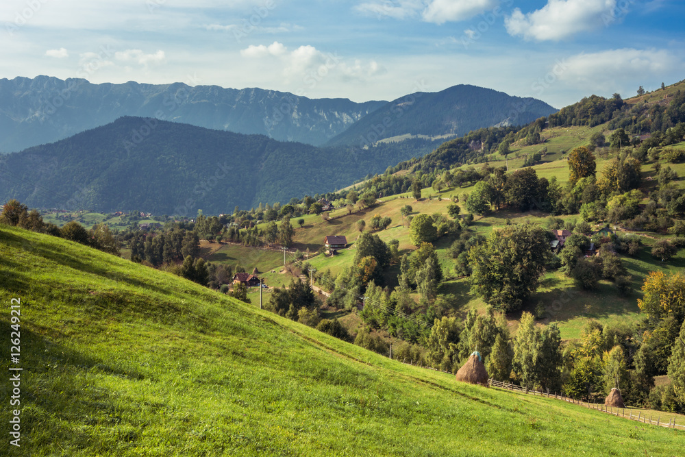 Mountain landscape in Romania. Rural Romanian landscape. Landscape of Magura Village near Brasov, Romania Mountain landscape in Romania. Rural Romanian landscape. Landscape of Magura Village near Brasov, Romania