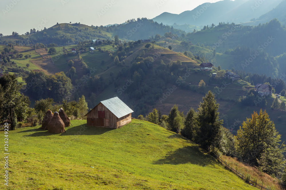 Mountain landscape in Romania with wooden hut. Landscape in Magura village, near Bran Castle. Mountain landscape in Romania with wooden hut. Landscape in Magura village, near Bran Castle.