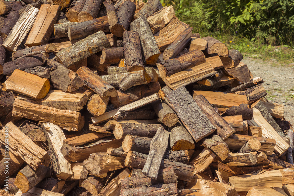 Stack of firewood. Wooden log. Pile of wood logs ready for winter Stack of firewood. Wooden log. Pile of wood logs ready for winter