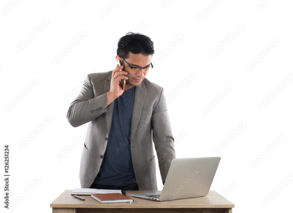 Businessman working on laptop and calling on phone, white backgr Businessman working on laptop and calling on phone, white backgr