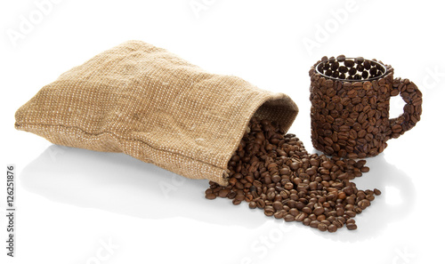 Cup of coffee beans and bag isolated on white.