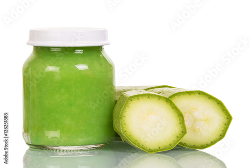 Courgettes and baby puree jar isolated on white.
