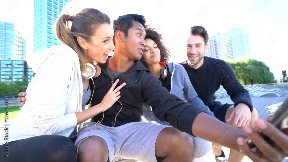 Group of friends in sports outfit taking selfie picture with smartphone Group of friends in sports outfit taking selfie picture with smartphone