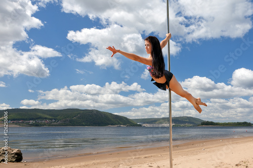 dancer on pole in strips summer beatch