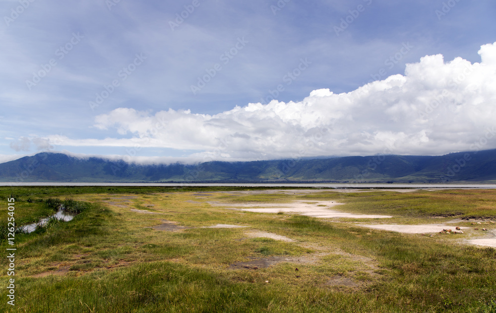 Ngorongoro Crater Conservation Area on a background cumulus clouds, Tanzania. East Africa