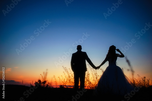 Couple in love silhouette during sunset