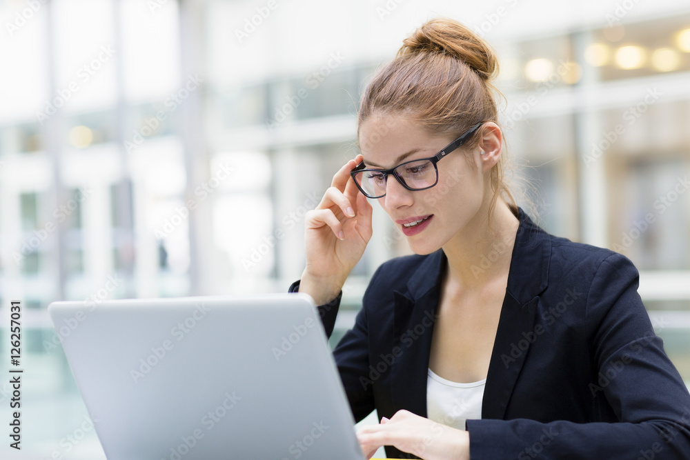Businesswoman working on laptop in office Businesswoman working on laptop in office