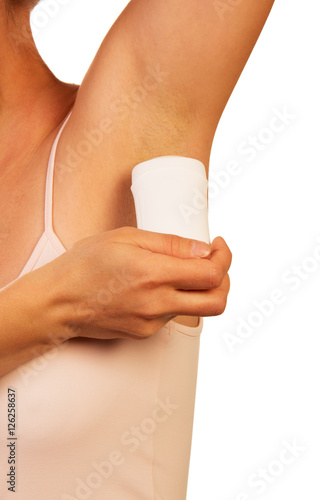 Unknown woman uses dry underarm deodorant isolated on white background. © laboko