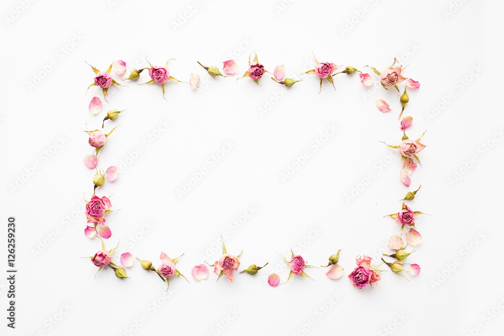 Frame made of pink dry roses and petals. Top view, greeting card.