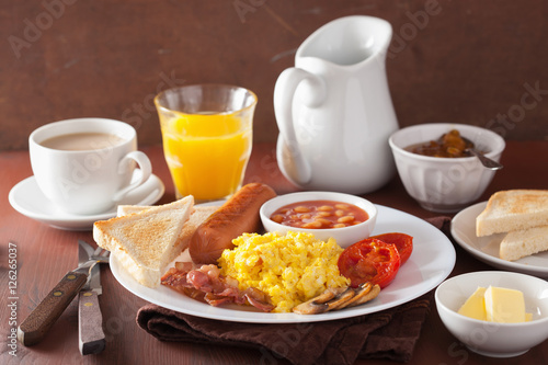 full english breakfast with scrambled eggs, bacon, sausage, bean