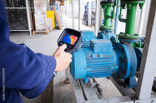 technician use thermal imaging camera to check temperature in fa