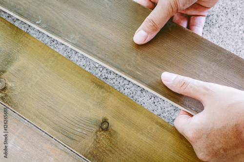 Carpenter worker installing laminate flooring