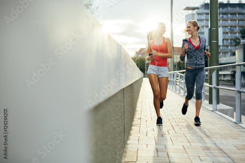 Two women exercising by jogging