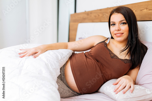 Portrait of pregnant woman in bed