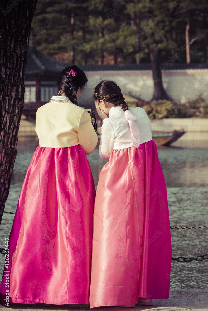 Young girls in traditional dresses at Gyeongbokgung Palace of Seoul, South Korea. Young girls in traditional dresses at Gyeongbokgung Palace of Seoul, South Korea.
