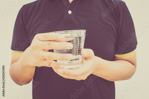 Man drinks a glass of water