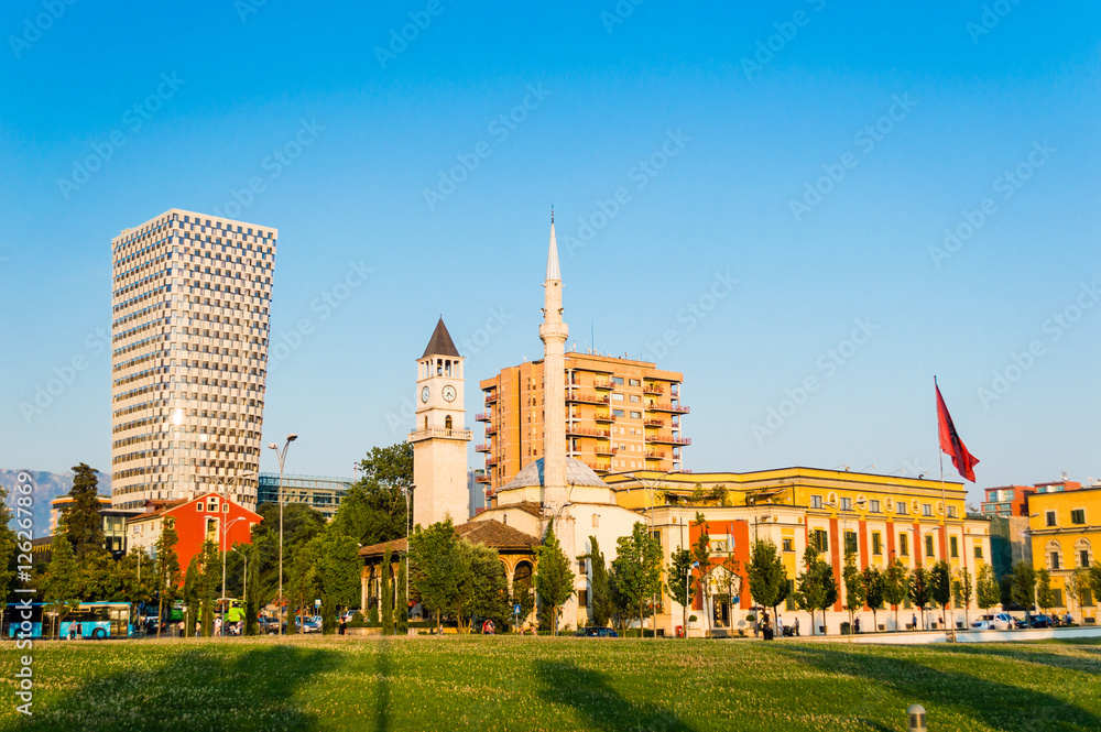 Skanderbeg square with flag, clock tower and The Et'hem Bey Mosque in the center of Tirana city, Albania.