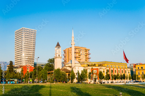 Skanderbeg square with flag, clock tower and The Et'hem Bey Mosque in the center of Tirana city, Albania.