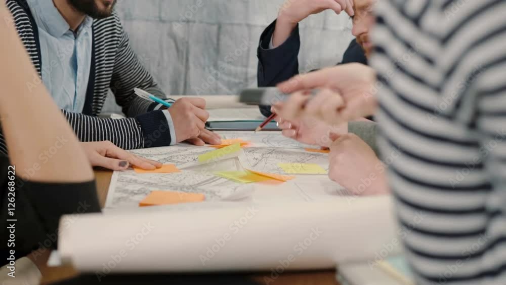 Creative small business team young architects meeting in startup office actively discussing new ideas Creative small business team young architects meeting in startup office actively discussing new ideas