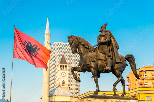 Skanderbeg square with flag, Skanderbeg monument and The Et'hem Bey Mosque in the center of Tirana city, Albania.