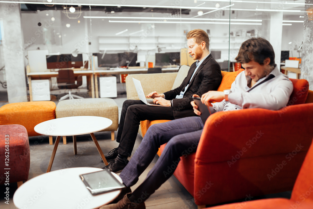 Succesful businesspeople working on devices Succesful businesspeople working on devices