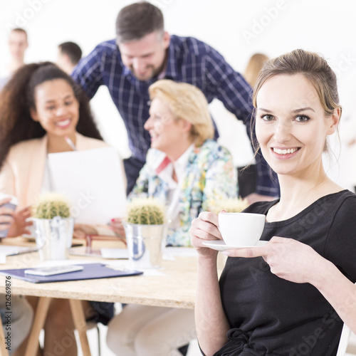 Young woman and a group of coworkers
