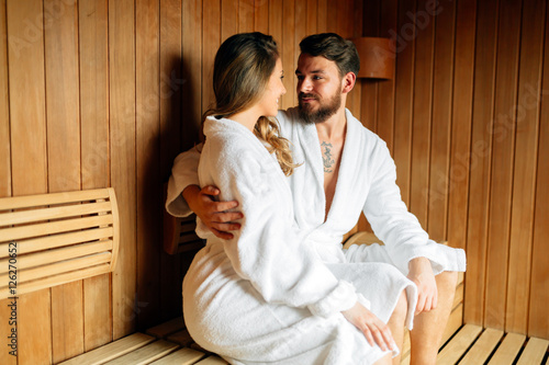 Happy couple enjoying serene moments in sauna