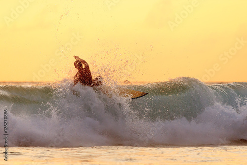 Surfer on the beach at Kata beach, Phuket, Thailand.