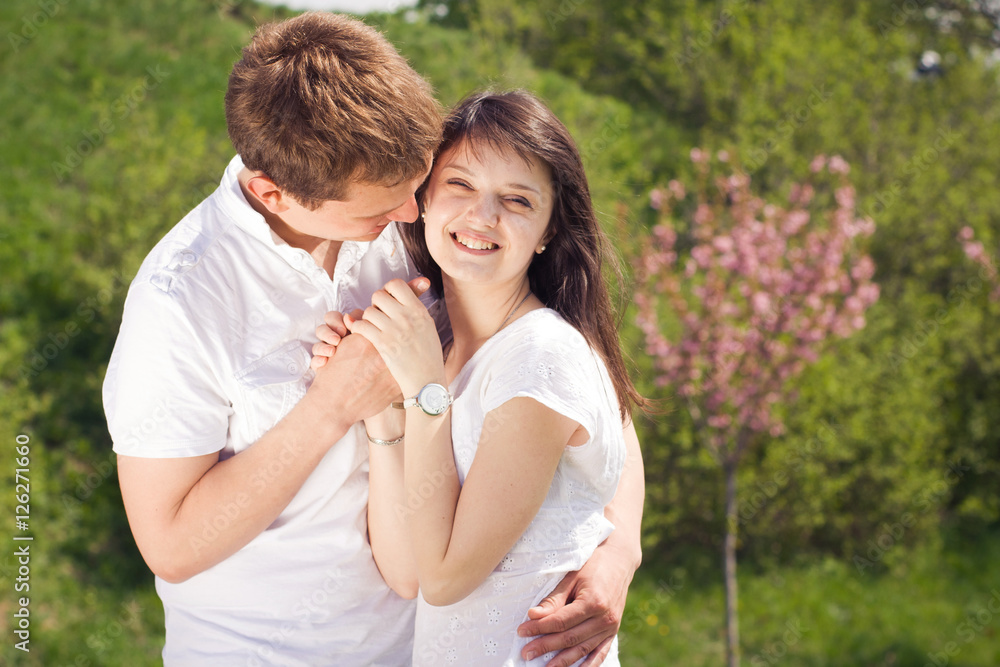 Loving young beautiful couple on a date in park. summer warm weather Loving young beautiful couple on a date in park. summer warm weather
