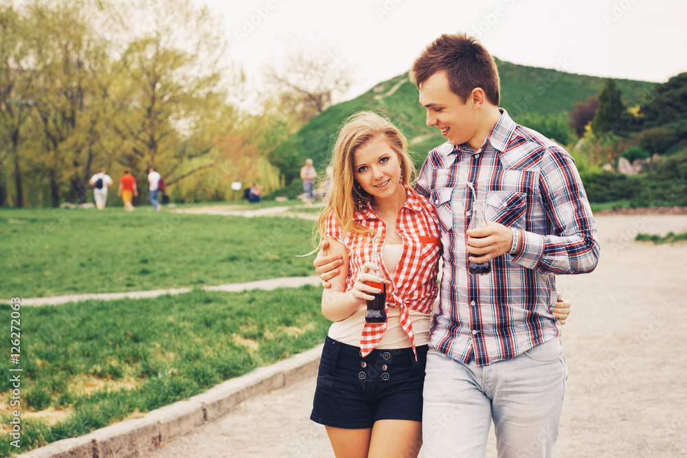 Loving young beautiful couple on a date in park. summer warm weather Loving young beautiful couple on a date in park. summer warm weather