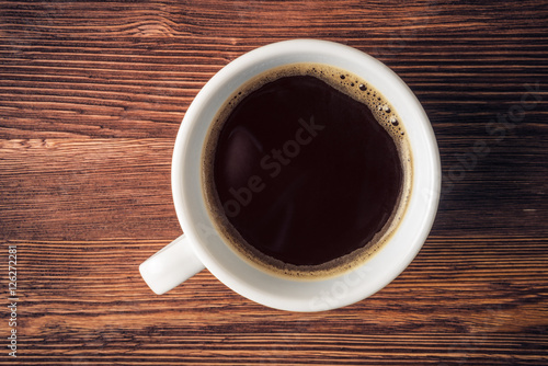 Coffee cup over old wooden background