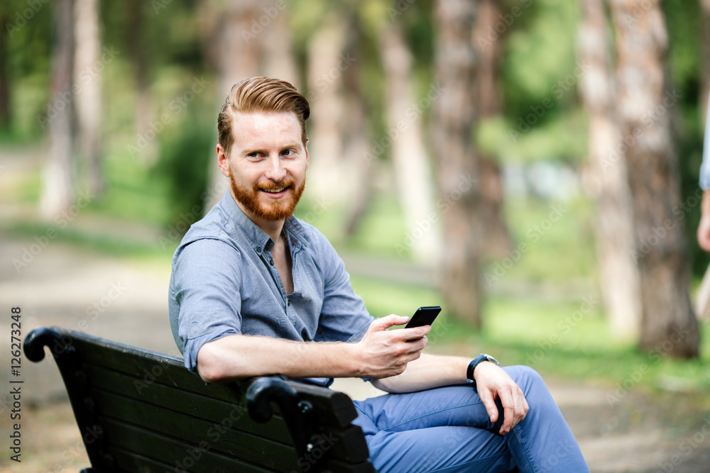 Fototapeta premium Handsome businessman using phone