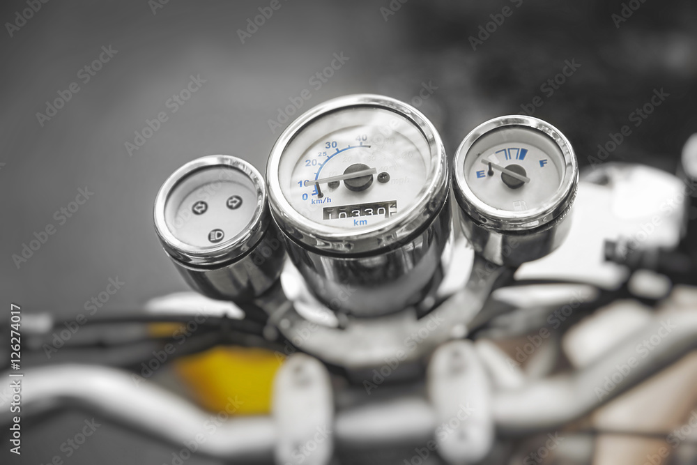 Obraz premium Motorcycle speedometer. Vintage motorbike. Devices on a steering bracket on the old bike.