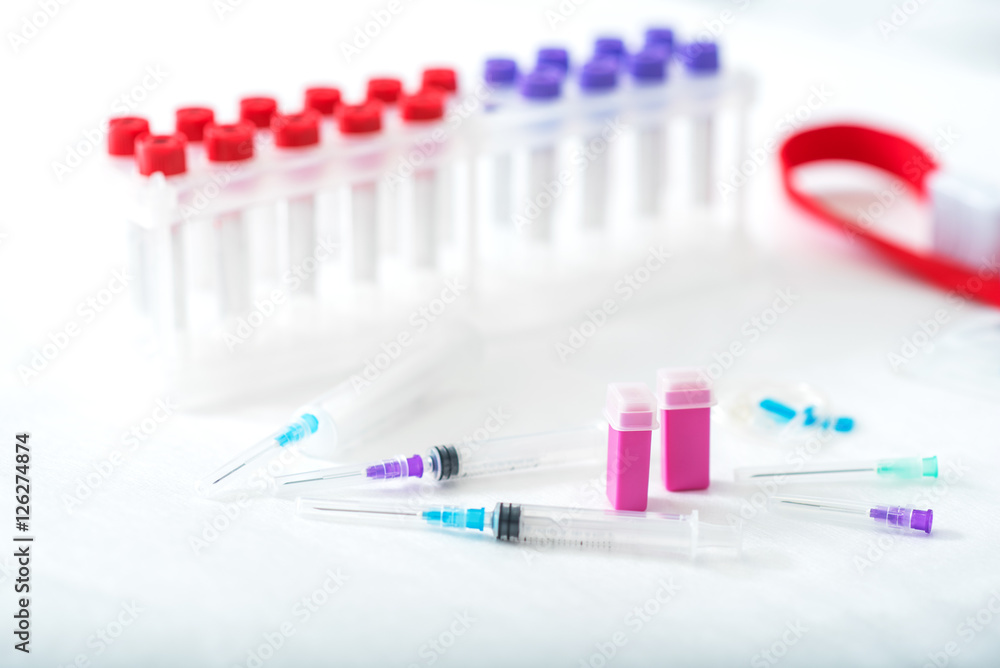 Medical test-tubes and needles for lab examination