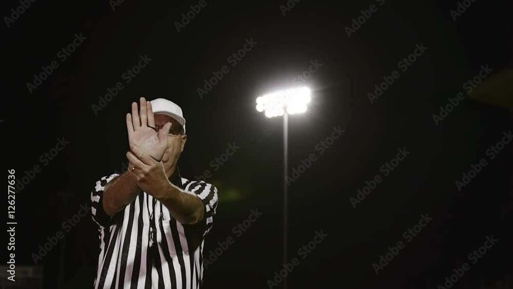 A football referee makes an illegal use of hands penalty signal A football referee makes an illegal use of hands penalty signal