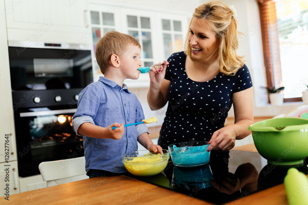 Child helping mother make muffins Child helping mother make muffins