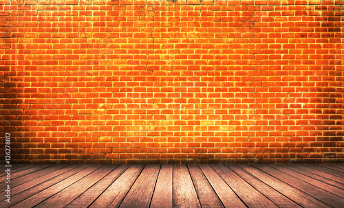Wood floor with red brick wall background