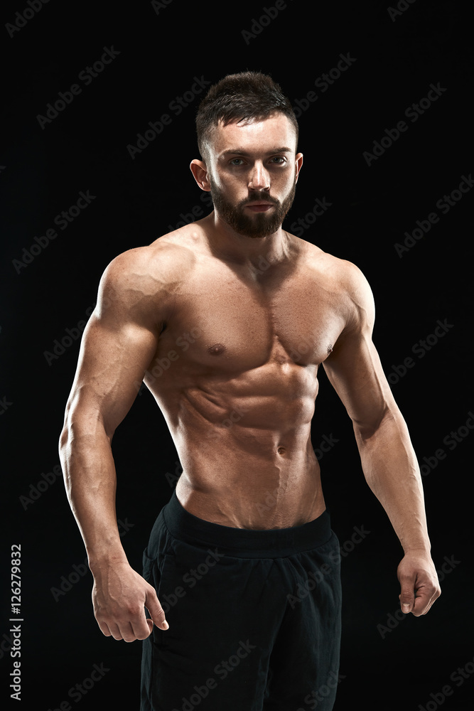 Muscular bodybuilder guy doing posing