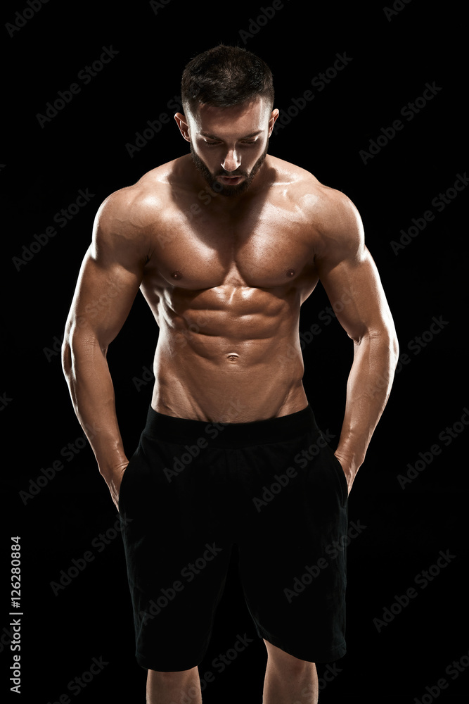 Fototapeta premium Muscular bodybuilder guy doing posing