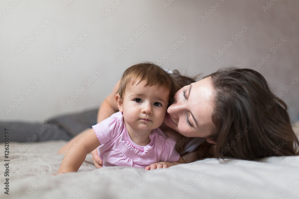 happy loving family. young mother playing with her baby in the b happy loving family. young mother playing with her baby in the b