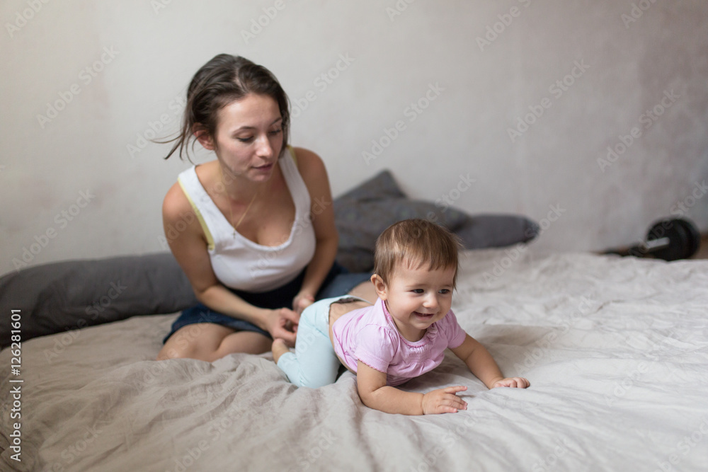 Mother doing massage your baby, . Cozy house, lifestyle, selecti Mother doing massage your baby, . Cozy house, lifestyle, selecti