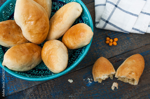 warm Russian pies with different fillings: meat, cabbage and apples. delicious with tea. photo